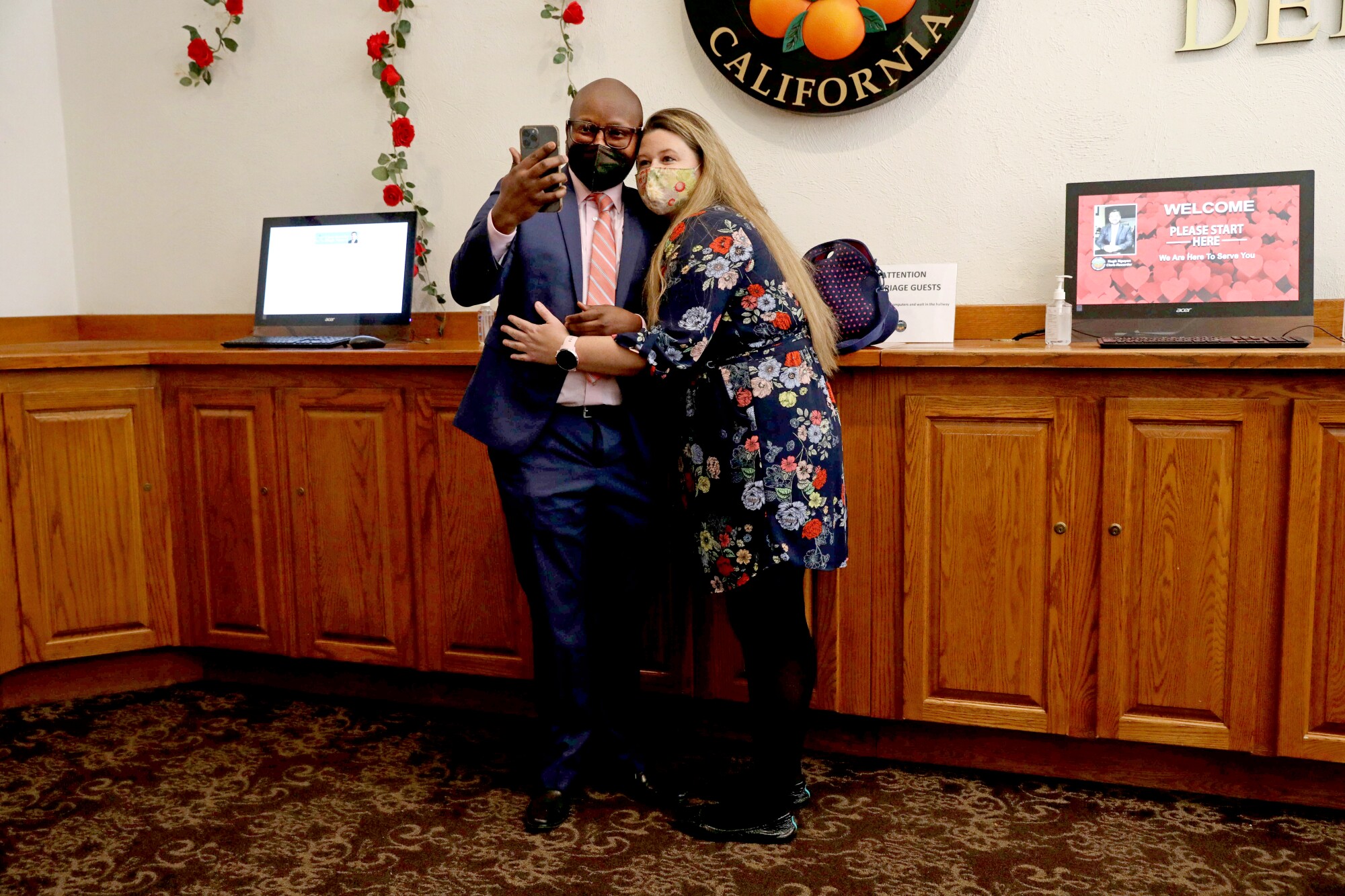 A couple takes a selfie after registering to marry on 2/22/22 at the Old County Courthouse in downtown Santa Ana.