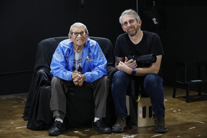 Photographer Mickey Strand, right, poses with World War II veteran Joe Albert Gonzalez, 95.