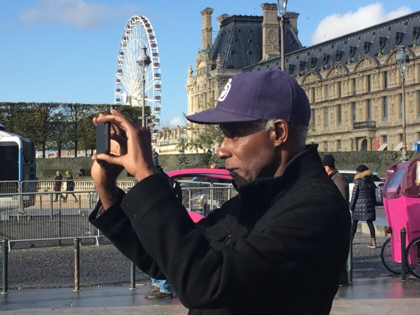 Gary Evans takes a picture with his phone in Paris.