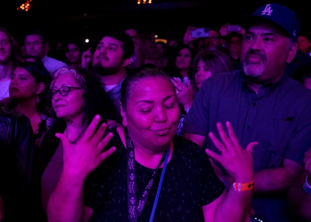 A fan dances as Los Lobos performs during a benefit...