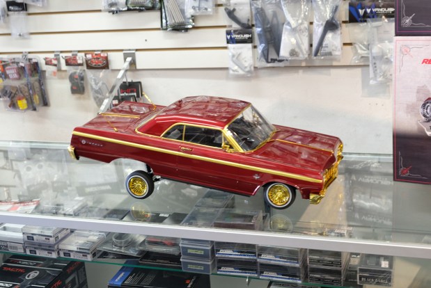 Patrick Peralta's custom radio-controlled 1964 Chevrolet Impala is displayed on the counter of the hobby shop where he works, RC Street Shop in Long Beach. (Photo by Victoria Johnson, Contributing Photographer)
