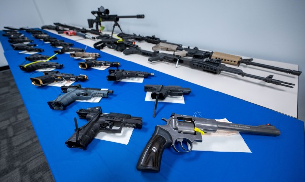 Guns seized during arrests on display during a press conference...