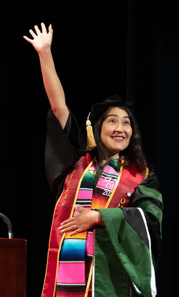 A graduate waves as the College of Podiatric Medicine and...