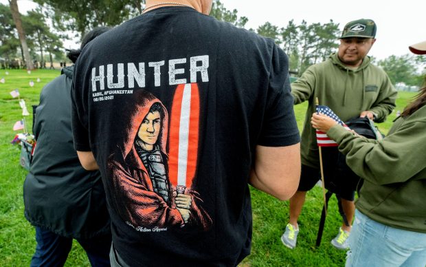 Herman Lopez wears a shirt with his son Hunter as...