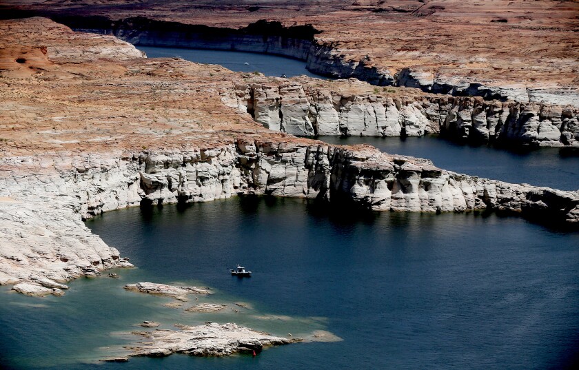 A boat floats on Lake Powell in Dec. 2021. 