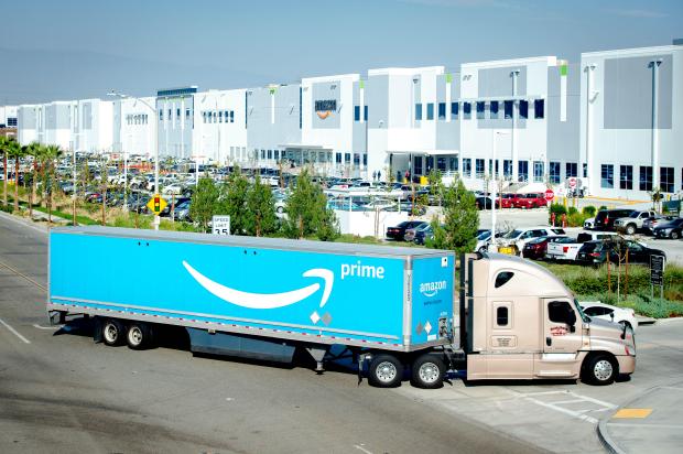 An Amazon truck pulls into one of the company’s enormous...