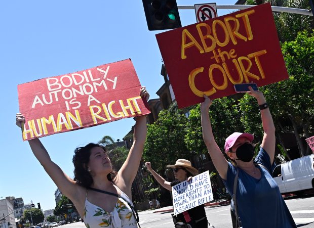 Activists march through downtown to protest the overturning of Roe...
