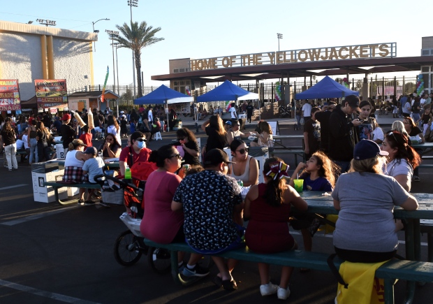 Colton residents eat from the food vendors during the city’s...