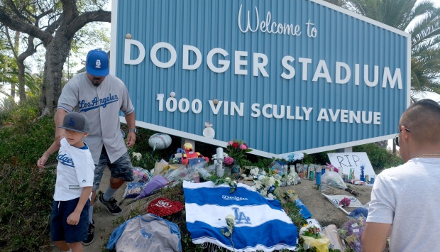 Los Angeles Dodger fans, including Rudy Escobar with his son...
