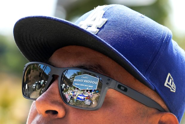 A makeshift memorial is reflected in a fans sunglasses as...
