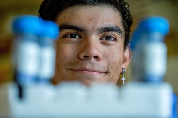 UCR student Daniel Gonzalez II, poses with soil samples in...