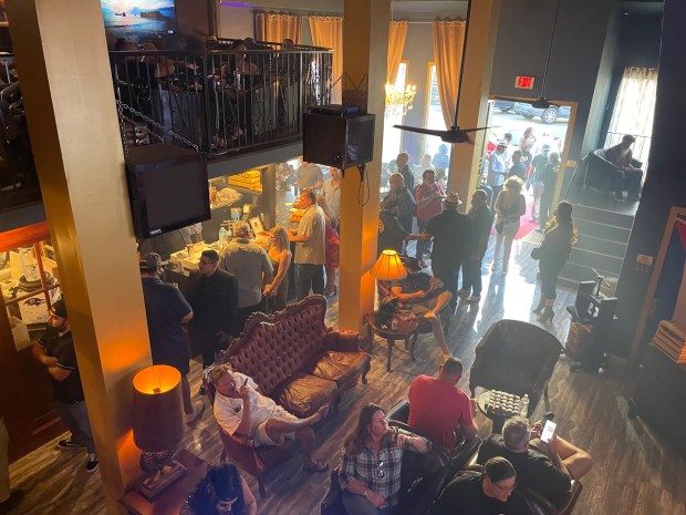 In this photo from Feb. 12, the day Mi Havana Cigar Lounge opened, patrons enjoy a smoke or check out the offerings in the speakeasy-style business. The owner sunk $800,000 into the renovation. (Photo by David Allen, Inland Valley Daily Bulletin/SCNG)