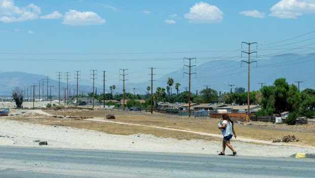 A woman walks by University Ave. in San Bernardino on...