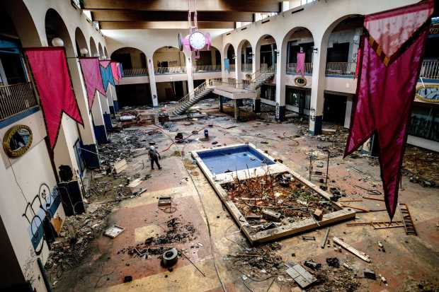 Security Melvin Fernandez patrols inside the abandoned Carousel Mall in...