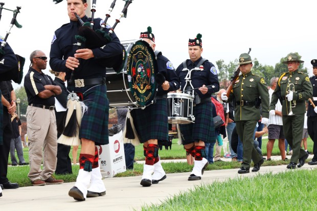 The Rancho Cucamonga Firefighters Pipes and Drums members march at...